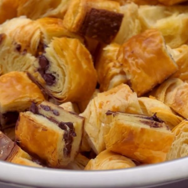 Close-up of a bowl filled with golden-brown, flaky pastries with chocolate filling from Alyce cafe.
